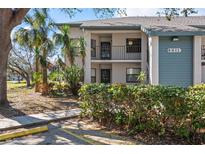 Condo exterior with beautiful landscaping and a charming two-story facade at 4411 46Th W Ave # 201, Bradenton, FL 34210