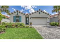 Charming single-story home with well-manicured lawn, tile roof and paver driveway at 491 Daylily Blvd, Nokomis, FL 34275