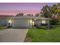 Charming single-story home featuring a well-manicured lawn, tile roof, and attached two-car garage at 6065 Marella Ct, Sarasota, FL 34243