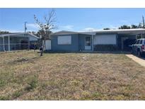 Modest single-story home with simple landscaping and a covered carport for convenient parking at 6803 Washington Pl, Bradenton, FL 34207