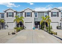 Charming townhomes with well-maintained landscaping, driveways, and two-car garages at 8979 Milestone Dr, Sarasota, FL 34238