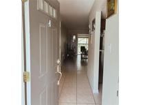 Inviting entryway featuring neutral tones, tile flooring, and a glimpse into the bright living area at 900 La Costa Cir # 4, Sarasota, FL 34237