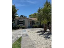 Charming single-story home featuring a walkway, lush landscaping, and a well-maintained lawn at 1132 26Th S Ave, St Petersburg, FL 33705