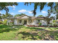 Charming one-story home featuring a well-manicured lawn, and a welcoming front porch at 13640 2Nd E Ave, Bradenton, FL 34212