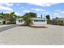 Charming single-story home featuring a well-maintained yard, rock landscaping, and a sunny blue sky at 1404 Dartmouth Dr, Bradenton, FL 34207