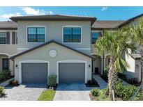 Attractive two-story townhome with neutral paint, dark trim, and well-maintained landscaping at 15164 Sunny Day Dr, Bradenton, FL 34211