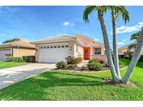 Charming single-story home with a well-maintained lawn and vibrant landscaping at 4200 Reflections Pkwy, Sarasota, FL 34233