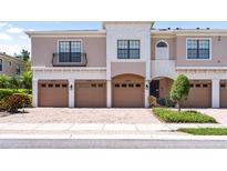 Attractive townhome featuring brick driveway, multiple garage doors, and neutral colored exterior at 4235 Overture Cir # 4235, Bradenton, FL 34209