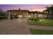 Stunning single-Gathering home featuring a porte-cochere and lush landscaping at 584 Mast Dr, Bradenton, FL 34208