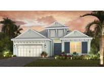Inviting two-story home featuring a two car garage, landscaped yard, and covered front entry at 6224 Isla Del Ray Ave, Sarasota, FL 34240