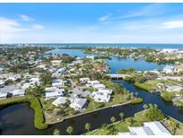 Beautiful aerial view of a waterfront community with canals and access to the ocean on a clear, sunny day at 107 Clipper Way # 107, Nokomis, FL 34275