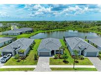 An aerial view of the home's tile roof and backyard pond at 11327 Burgundy Dr, Venice, FL 34293