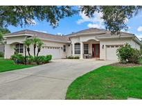 Stunning single Gathering home with a well manicured lawn, three car garage and beautiful curb appeal at 11508 30Th E Cv, Parrish, FL 34219