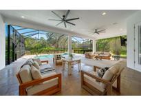 Spacious covered patio with comfortable seating, ceiling fans, and an outdoor pool at 14901 17Th E Ave, Bradenton, FL 34212