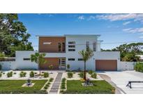 Modern two-story home showcasing a minimalist design, desert-style landscaping, and a two-car garage at 2124 Clematis Pl, Sarasota, FL 34239