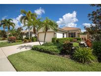 Charming single-story home boasts a well-manicured lawn, lush landscaping, and a welcoming two-car garage at 234 Padova Way, North Venice, FL 34275