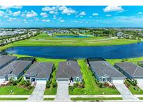 Beautiful aerial view of homes surrounding a scenic lake in a vibrant community at 4324 Dairy Ct, Lakewood Ranch, FL 34211