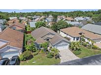 An aerial view of a charming single-Gathering home surrounded by mature trees and lush landscaping at 4330 Beekman Pl # 103, Sarasota, FL 34235
