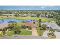 Stunning aerial view of a home with a lake, golf course and lush landscaping in a beautiful community at 4330 Presidential Avenue E Cir, Bradenton, FL 34203