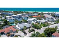 Beautiful aerial view of a beachfront home near shops, restaurants, and white sandy beach at 444 S Polk Dr, Sarasota, FL 34236