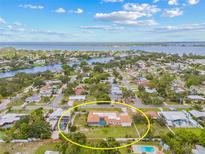 Stunning aerial view of a single-Gathering home with a screened pool and lush landscaping near the water at 6103 6Th Nw Ave, Bradenton, FL 34209