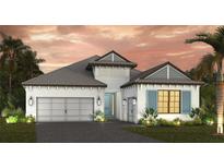Beautiful single-Gathering home boasting a two-car garage, white exterior, and lovely tropical landscaping at 6204 Isla Del Ray Ave, Sarasota, FL 34240