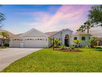 Beautiful single-story home with a well-manicured lawn and three-car garage at 7727 Heyward Cir, University Park, FL 34201