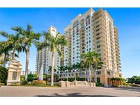 Beautiful exterior view of the Alinari building, complete with palm trees, and a gorgeous fountain entrance at 800 N Tamiami Trl # 405, Sarasota, FL 34236