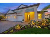 Charming single Gathering home featuring a two-car garage and beautifully landscaped front yard at 11422 Apple Tree Cir, Bradenton, FL 34211