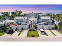 Charming townhome with a two-car garage, lush landscaping, and a metal roof in a desirable community at 1240 Siesta Bayside Dr # 1240C, Sarasota, FL 34242