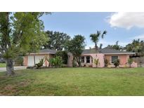 Charming single-story home featuring a well-manicured lawn, lush landscaping, and an attached garage at 1308 63Rd Nw St, Bradenton, FL 34209