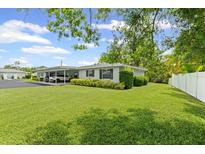 Well-maintained home with green lawn, covered parking, and manicured shrubs enhancing its curb appeal at 2115 9Th W Ave # 3D, Bradenton, FL 34205