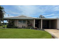 Charming single-story home with a well-manicured lawn, mature landscaping and convenient covered parking at 3262 Brunswick Ln # 707, Sarasota, FL 34239