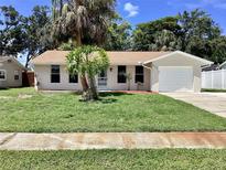 Charming single-story home with a well-manicured lawn and lush tropical landscaping in a desirable neighborhood at 4112 Cochise Ter, Sarasota, FL 34233