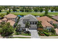 Stunning two-story home with well-manicured landscaping, tile roof and beautiful water view at 7634 Windy Hill Cv, Bradenton, FL 34202