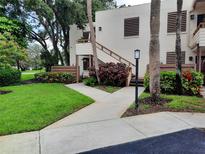 Condo exterior with a landscaped yard and walkway leading to a private entrance with stairs at 137 Pineneedle Dr # 137, Bradenton, FL 34210