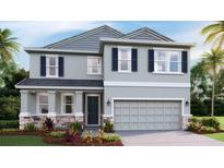 Beautiful two-story home featuring a stylish gray exterior, well-manicured landscaping, and an attached two-car garage at 18329 Thistleberry Pl, Lakewood Ranch, FL 34211