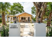 Charming home with modern address markers, a cozy porch, and a xeriscaped front yard for low maintenance at 2189 Hillview St, Sarasota, FL 34239