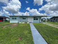 Charming single story home with a well-maintained lawn and inviting front entrance at 22214 Felton Ave, Port Charlotte, FL 33952