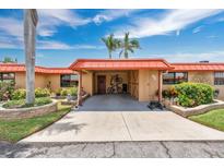 Charming home featuring well-kept landscaping, an orange roof, and a covered carport at 3850 Catalina Dr, Bradenton, FL 34210
