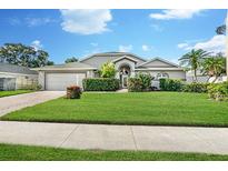 Charming single story home with lush lawn, mature landscaping, brick driveway, and attached two car garage at 5206 19Th W Ave, Bradenton, FL 34209