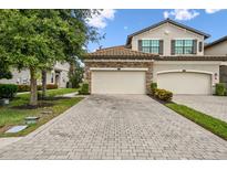 Beautiful two-story home with a three-car garage and stone accents on the facade at 5916 Wake Forest Run # 101, Bradenton, FL 34211
