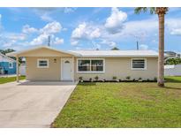 Charming single-story home with well-maintained lawn and modern landscaping, complemented by a clean, concrete driveway at 609 Carmel Rd, Venice, FL 34293