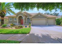 Charming single-story home with a well-manicured lawn, mature trees, and a three-car garage at 695 Rivendell Blvd, Osprey, FL 34229