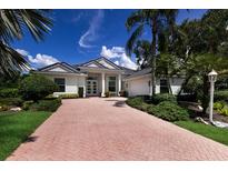 Stunning single-story home with a beautifully landscaped yard and inviting brick driveway at 7211 Marston Ct, University Park, FL 34201