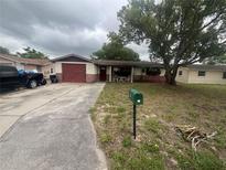 Charming single-story home featuring an attached garage and well-maintained front yard at 11234 Areca Dr, Port Richey, FL 34668