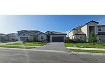 Beautifully landscaped homes with paved driveways create an inviting street view at 15115 Oxford Grey Dr, Bradenton, FL 34211