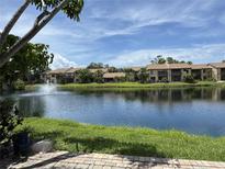 Water view of the apartment buildings with a fountain in the center of the lake on a sunny day at 3810 75Th W St # 137, Bradenton, FL 34209