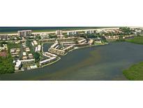 Waterfront condos with pools, docks, and tropical landscaping offer a luxurious coastal living experience at 4380 Exeter Dr # 204, Longboat Key, FL 34228