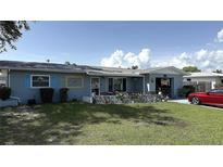 Charming single-story home with a cozy front porch and well-maintained lawn, creating a welcoming curb appeal at 453 Sandlewood Dr, Venice, FL 34293